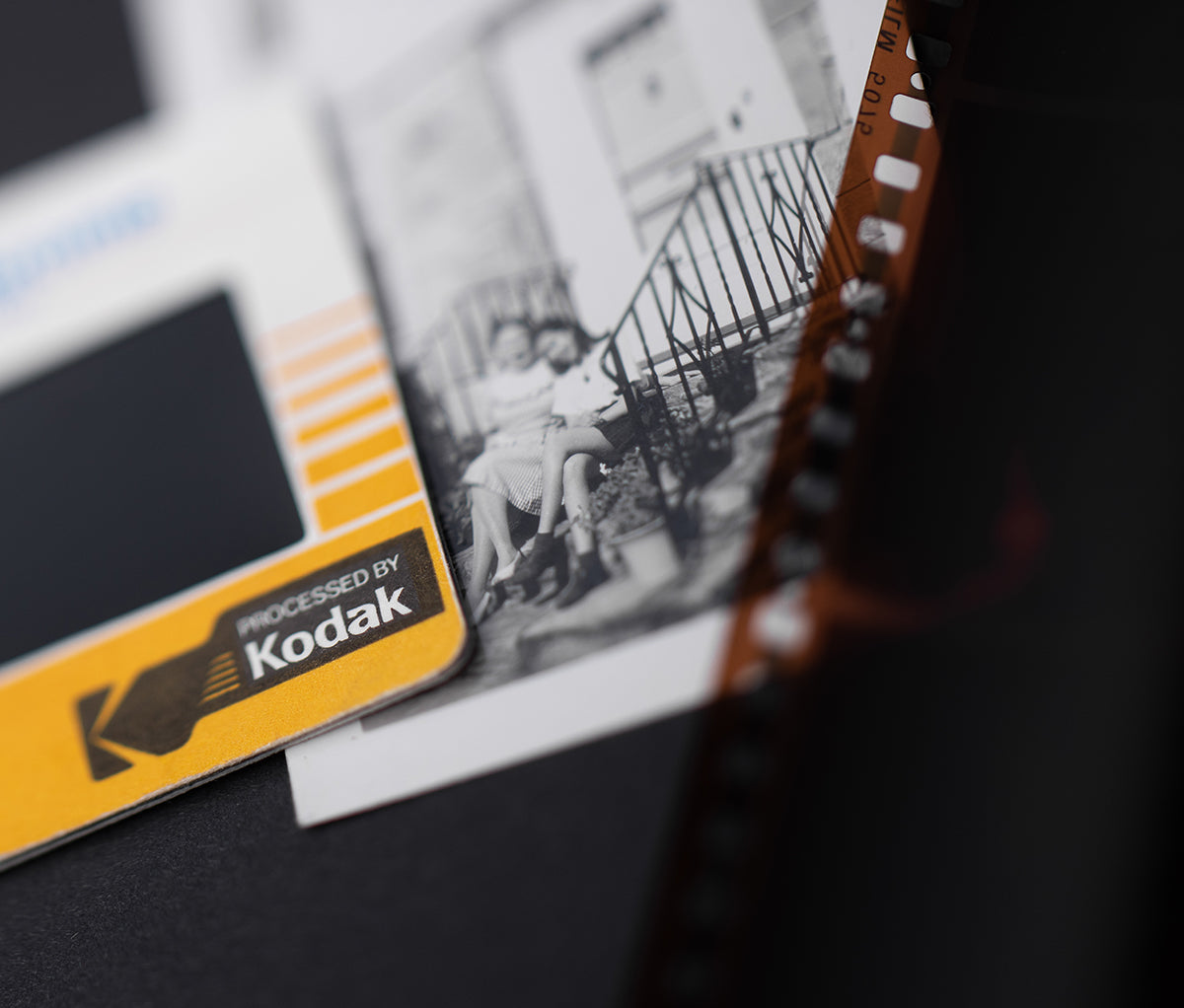 Close-up of a real mounted KODAK slide beside an original photograph and negative